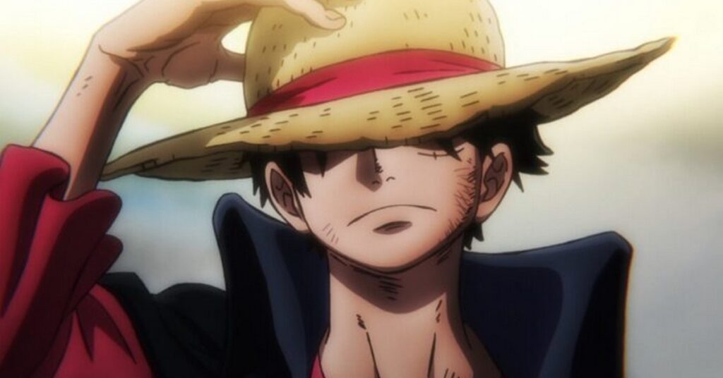 Personaje Luffy ajustándose el sombrero.