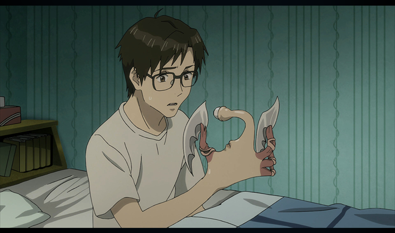 The character Shinichi Izumi sitting on the bed and looking at his hand which is undergoing a mutation due to the parasite.