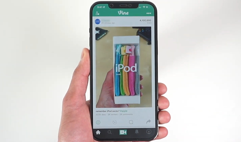 Image of a person holding a cell phone whose screen displays the Vine app interface