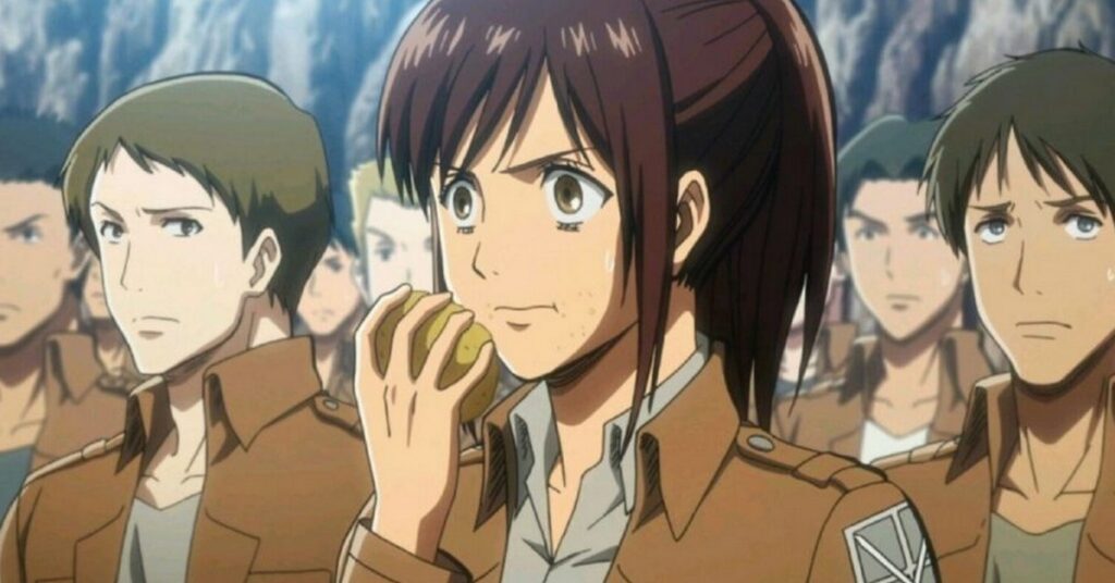 Personagem feminina de Attack on Titan, Sasha, na cena em que ela come uma batata escondida