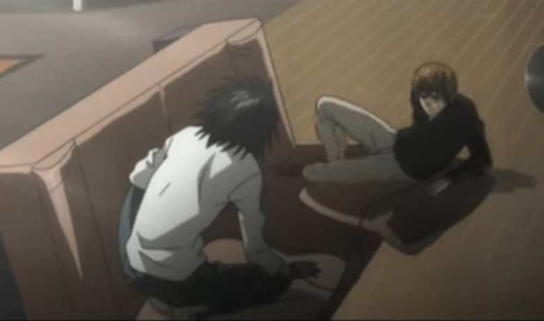 Image shows the two characters, L and Kira, sitting on the floor while facing each other