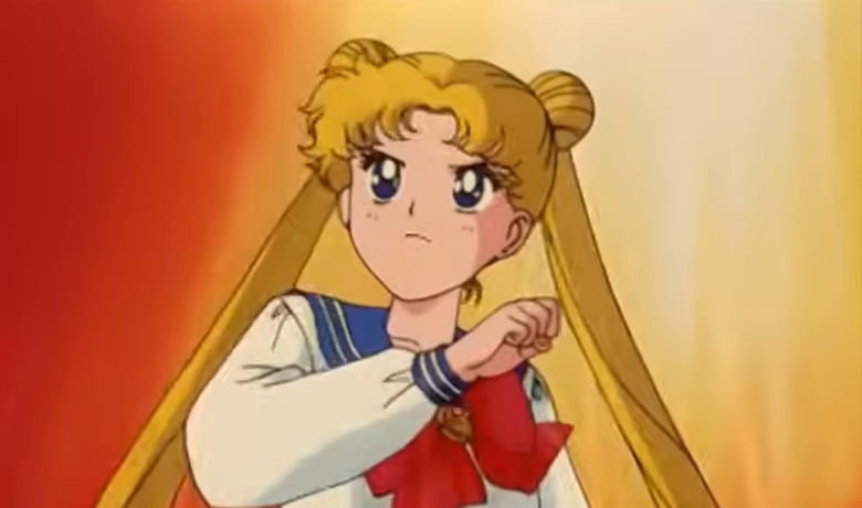 Image shows character Usagi with a serious expression on her face wearing her traditional uniform